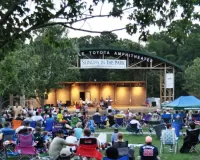 A group of people enjoying a concert at the Town Common in Greenville, NC