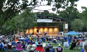 A group of people enjoying a concert at the Town Common in Greenville, NC