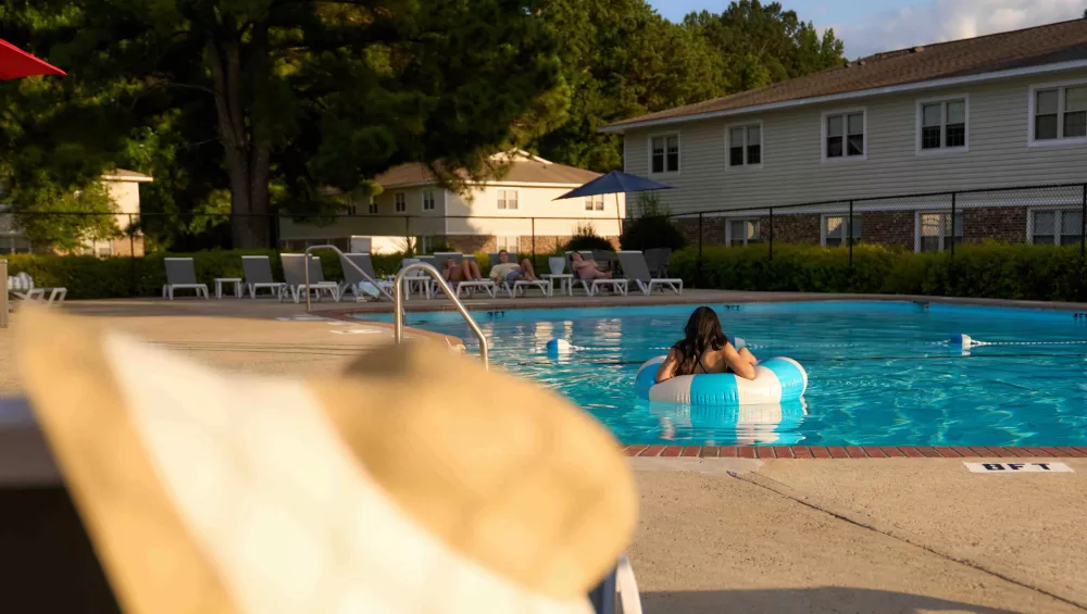 Residents at the community pool at Eastbrook Apartments in Greenville, NC