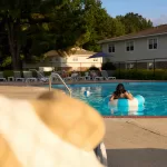 Residents at the community pool at Eastbrook Apartments in Greenville, NC